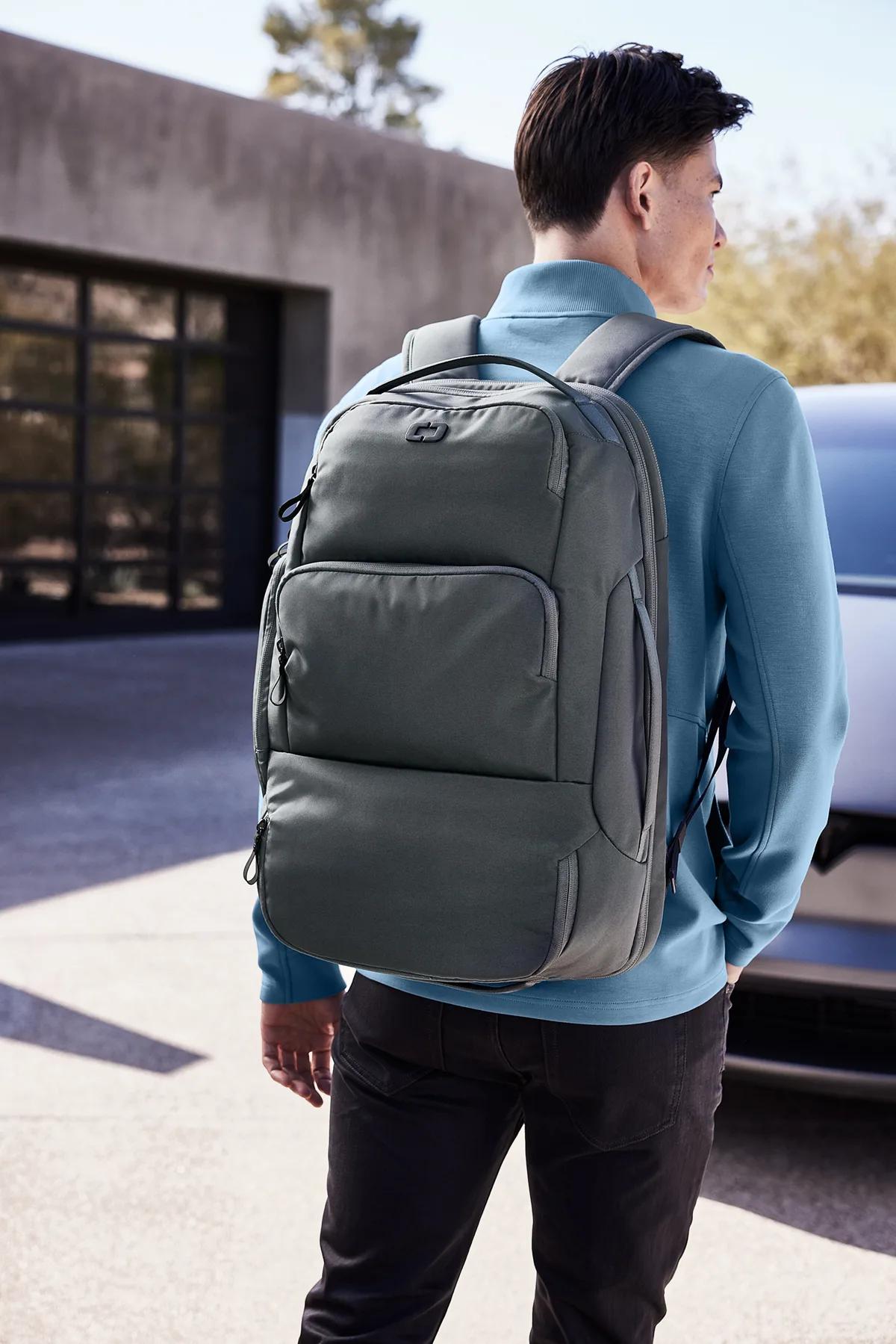 Man carrying an OGIO Ultimate travel backpack